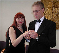 The groom gives his fiancee a ring